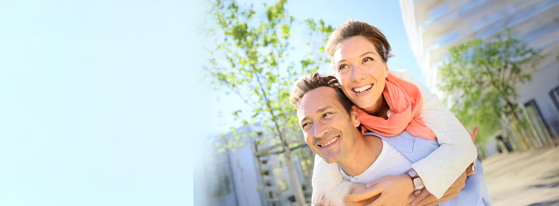 The image shows a man and woman embracing each other outdoors during daylight they appear to be enjoying a pleasant moment together.